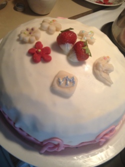 Strawberries filled dark chocolate cake. Covered and decorated with sugar paste.